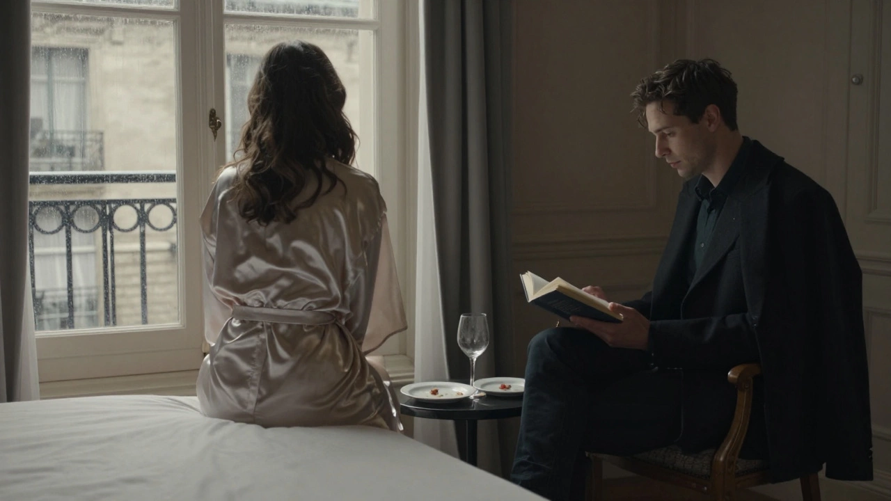 A man and woman sit silently in a Paris hotel room, no touch, just presence, rain falling outside.